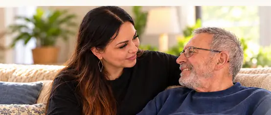 Andi sitting with an older adult